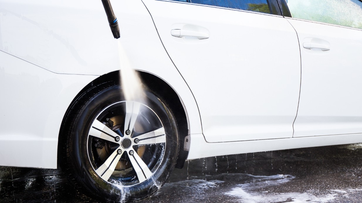 Høytrykkspyler felg på hvit bil